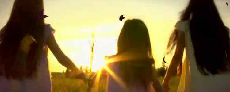 little girls walking in a field