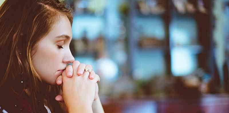 woman praying in a church